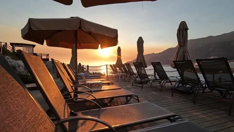 Kas, Turkey - August 29, 2026 Sun loungers and umbrellas at sunset Stock Footage 345138862