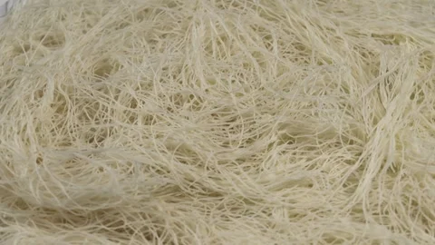 Kataifi dough, rotation in circle. shredded phyllo dough, Turning. Raw kunafa Stock Footage 293232575