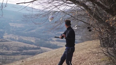 Katana Target Training: Precise Martial Arts Practice Amid Scenic Hillside Stock Footage 309855792