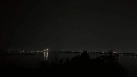 Kathajodi River at Night with Distant City Lights and Reflections Stock Footage 340500029