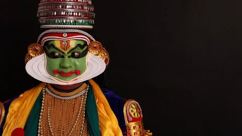 Kathakali dancer giving an expression with his eyes and eyebrows.  Stock Footage 125356975