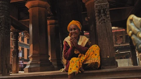 KATHMANDU, NEPAL - CIRCA, 2019: Affable smiling nepalese woman sitting on stairs Stock Footage 124677481