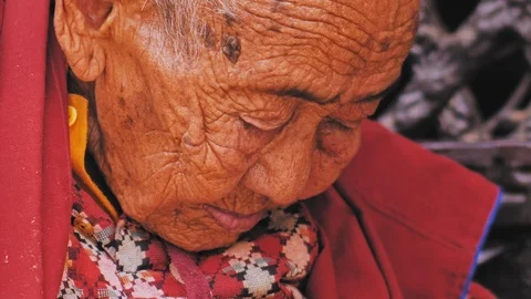 KATHMANDU, NEPAL - CIRCA, 2019: Very old nun, wrinkly skin, ancient age woman Stock Footage 124677756