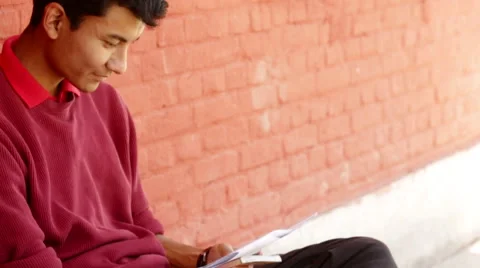 Kathmandu Nepal student reading notes for a class in Eastern Kathmandu, Nepal Видео 45207529