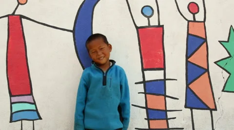 Kathmandu Nepal young boy posing in front of mural at childrens home in Eastern 動画素材 47335100