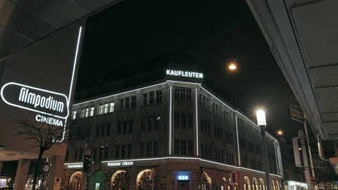 Kaufleuten and filmpodium cinema neon text lights at night in Zurich Switzerland Stock Footage