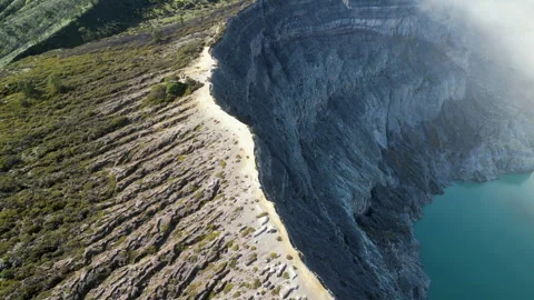 Kawah Ijen Crater Rim Java Indonesia Drone Tracks Left Across Rocky Edge 4K Video stock 327799084
