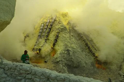 KAWAH IJEN VOLCANO, EAST JAVA, INDONESIA, 2 June, 2021. Sulfur miner collecting Foto stock