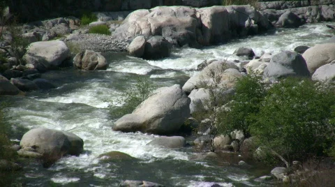 Kaweah River flows downstream through the rocks, creating whitewater rapids Stock Footage 360333