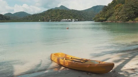 Kayak on a beach with shadow of coconut trees Stock Footage 232907694