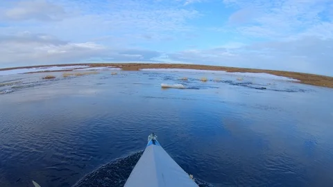 Kayak bow cuts through river with melting ice fish eye Stock Footage 125007633