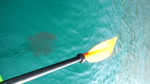 Kayak, paddle, sunset - Low angle view over clear azure sea water. Sun glare Stock Footage 277038715
