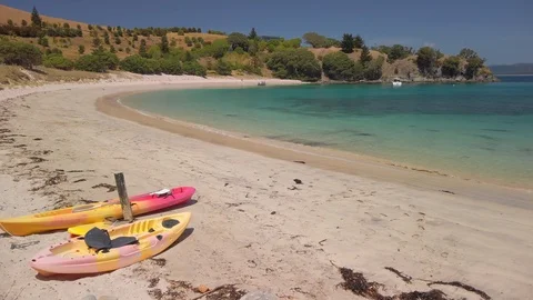 A kayak pulled up on the shoreline of a tropical beach Stock Footage 125110650