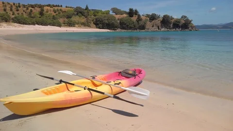 A kayak pulled up on the shoreline of a tropical beach Stock Footage 125113771