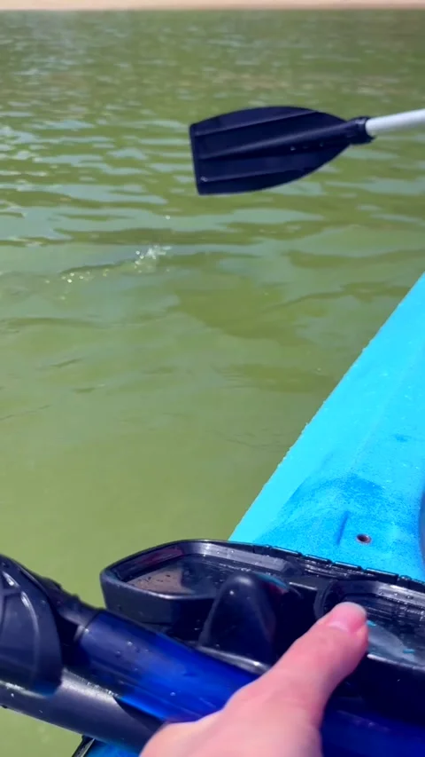 Kayak slowly approaches sandy beach with gentle paddle strokes, calm tropical Stock Footage 337104690