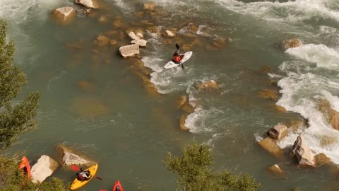 Kayak starting into white water rapids -medium shot from above Stock Footage 98307828