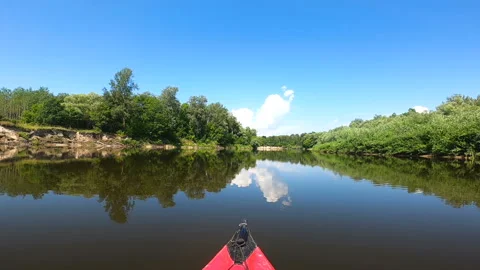 Kayak went down river with reflections of clouds in water. Travel  Video stock 166392777