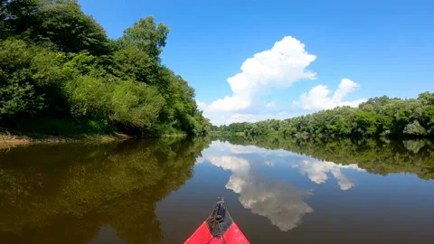 Kayak went down summer river with reflections of clouds  Stock Footage 166442410
