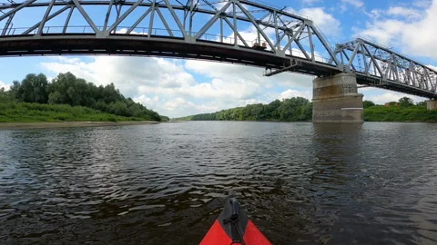 Kayak went down summer river under the bridge.  Video stock 166447739