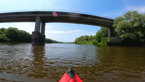 Kayak went down summer river under the stone bridge.  Video stock 166804917
