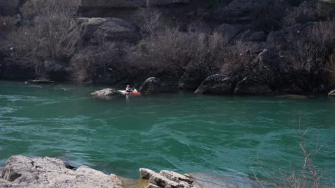 Kayaker in a cool mountain river with fast flowing river practice sports Stock Footage 104837539