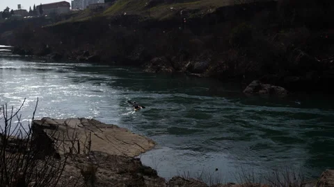 Kayaker in a cool mountain river with fast flowing river practice sports Stock Footage 104838715