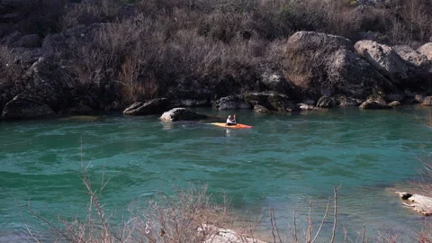 Kayaker in a cool mountain river with fast flowing river practice sports Stock Footage 104858760