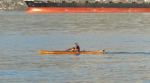 Kayaker crossing harbour Stock Footage 37687758