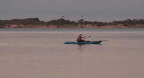 Kayaker in evening bay 写真素材