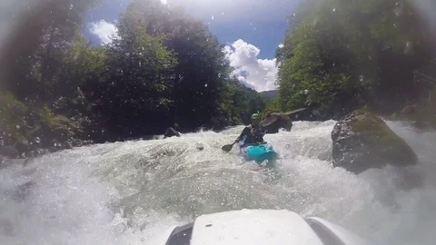 Kayaker kayaking in powerful river rapids Stock Footage 72505513