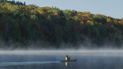 Kayaker on mountain lake - 1 Stock Footage 238794921