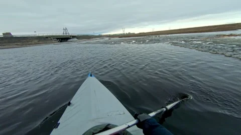 A kayaker navigates through icy waters in a vast arctic landscape. The scene Stock-Footage 278702015