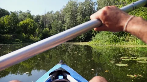Kayaker navigating through serene waters, capturing the essence of outdoor Video stock 317372487