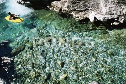 Kayaker outdoors sitting in small kayak in water (selective focus) Stock Photos