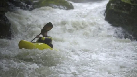 Kayaker paddling through powerful rapids Stock Footage 72506598