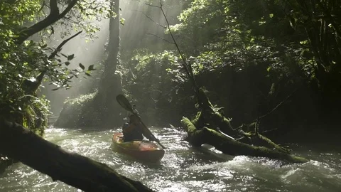 Kayaker paddling through river rapids 스톡 동영상 72507436