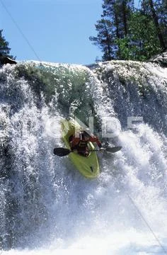 Kayaker in rapids going over waterfall Stock Photos