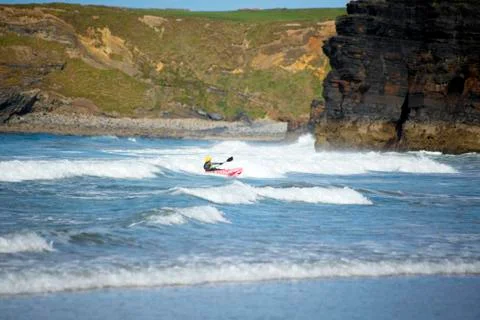 Kayaker riding waves at ballybunion Stock Photos