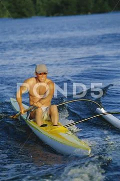 Kayaker rowing in calm waters (selective focus) Stock Photos