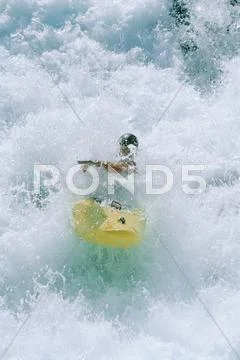 Kayaker rowing in rapids Stock Photos