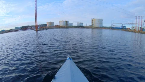 Kayaker sails on rowing foldboat to town with gas tanks Stock Footage 123863567
