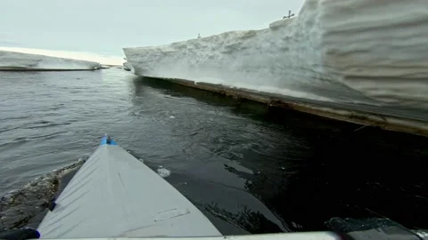 Kayaker spends vacation sailing on ice canoe past glaciers Stock Footage 203956221
