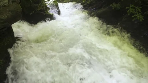 Kayaker standing on a rock and looking at rapid Stock Footage 72501426