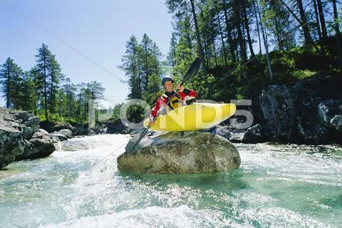 Kayaker on top of rock in rapids smiling Stock Photos