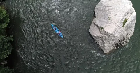 Kayakers navigate a rock in the river, viewed from above in Ardèche Stock Footage 290958853
