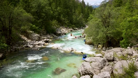 Kayakers Navigating Emerald Soca River Rapids in Slovenia Stock Footage 340397787