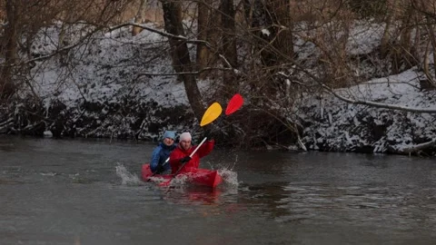 Kayakers navigating a winter river while enjoying an adventurous outing. Video stock 299023994