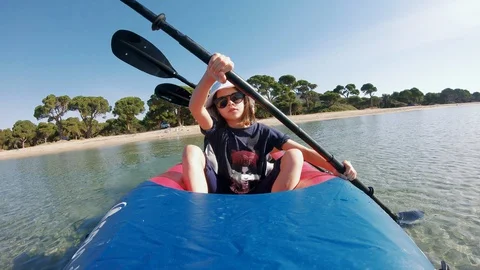 Kayakers paddle on inflatable three seats kayak near a tropical Island Video stock 130126832
