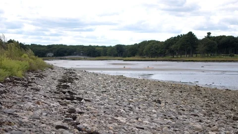 Kayaking down river with rocks along shorline Stock-Footage 116789799