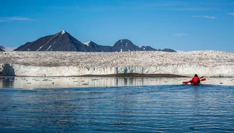 Kayaking in front of a glacier Stock Photos